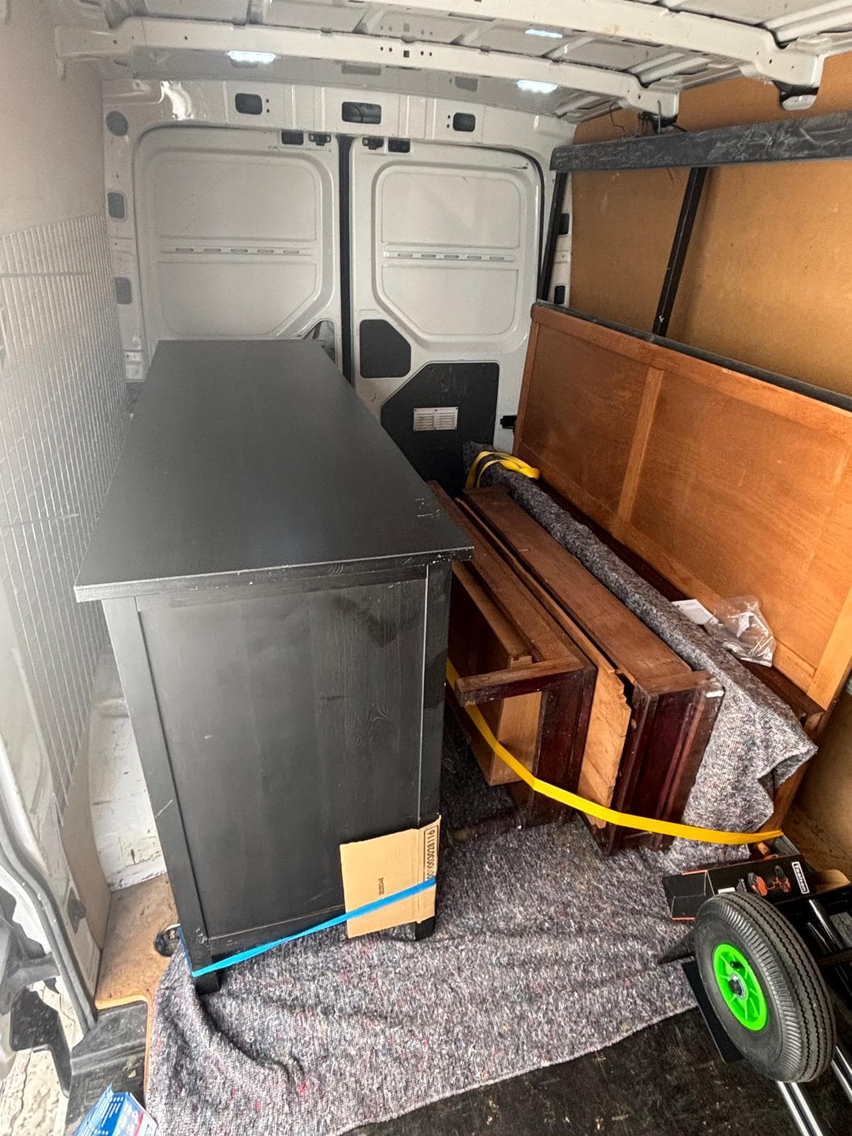 Campsil van loaded with furniture protected with blankets and a trolley to carry it up