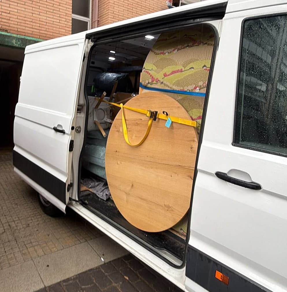 Round table and mattress from a small move, strapped inside Campsil's van in Barcelona